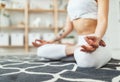 Woman doing yoga, meditating in Lotus position at home Royalty Free Stock Photo