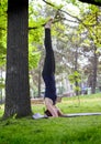 Young woman doing yoga in morning park