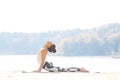 Young woman doing yoga near lake outdoors, meditation. Sport fitness and exercising in nature. Autumn sunset. Royalty Free Stock Photo