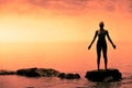 Young Woman doing Yoga Position in Front of the Ocean Royalty Free Stock Photo