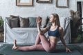 Young woman doing yoga, sitting on exercise mat Royalty Free Stock Photo