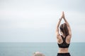 Young woman doing Yoga and stretching muscle in morning, healthy girl meditation against ocean view. wellness, fitness, Vitality, Royalty Free Stock Photo