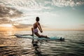 Young woman doing YOGA on a SUP board in the lake Royalty Free Stock Photo