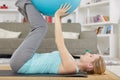 young woman doing yoga with yoga ball