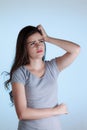 Young woman with doubt expression. Woman scratching her head