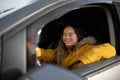 Young woman with Down syndrome driving a car and smiling. Royalty Free Stock Photo