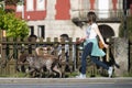 A young woman is dragged along by two hunting dogs