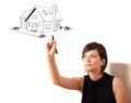 Young woman drawing a house on whiteboard Royalty Free Stock Photo