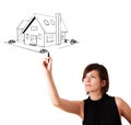 Young woman drawing a house on whiteboard Royalty Free Stock Photo