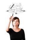 Young woman drawing a house on whiteboard Royalty Free Stock Photo