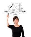 Young woman drawing a house on whiteboard Royalty Free Stock Photo