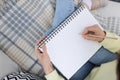 Young woman drawing in sketchbook on sofa, top view Royalty Free Stock Photo