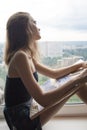 Young woman is drawing a watercolor painting on paper. The female artist paints watercolour landscape Royalty Free Stock Photo