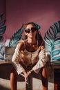 Young woman looking at camera sitting in bali cafe