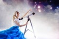 Young woman dreams of the future, concept. Girl looks up and uses a telescope. Starry sky behind the clouds