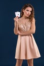 Young woman holding playing cards against dark background. Studio shot Royalty Free Stock Photo