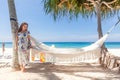 Young Woman in Dress Standing Near Hammock Between Palm Trees Royalty Free Stock Photo