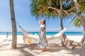 Young Woman in Dress Standing Near Hammock Between Palm Trees Royalty Free Stock Photo