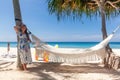 Young Woman in Dress Standing Near Hammock Between Palm Trees Royalty Free Stock Photo