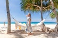 Young Woman in Dress Standing Near Hammock Between Palm Trees Royalty Free Stock Photo