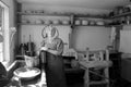 Young woman dressed as pilgrim in typical kitchen,Old Sturbridge Village,Mass,2014