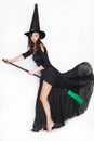 Young woman dressed as a witch on Halloween on an isolated background