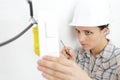 young woman drilling screws into plasterboard with screwdriver Royalty Free Stock Photo