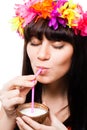 Young woman drink coconut milk from shell