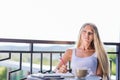 Young woman drink coffee and writing in note book journal in cafe