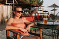 Young woman drinking beer in a beach bar Royalty Free Stock Photo