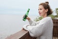 Young Woman Drinking Beer in Lake House Royalty Free Stock Photo