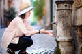 Young woman drinking clean water from the fountain in Rome, Italy Royalty Free Stock Photo