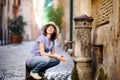 Young woman drinking clean water from the fountain in Rome, Italy Royalty Free Stock Photo