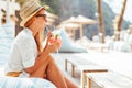 Young woman drinking cocktail in a beach bar Royalty Free Stock Photo