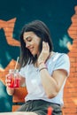 Young woman drinking cocktail in outdoor cafe Royalty Free Stock Photo