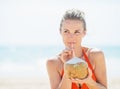 Young woman drinking coconut milk on beach Royalty Free Stock Photo