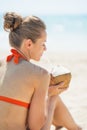 Young woman drinking coconut milk on beach Royalty Free Stock Photo