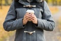 Young woman drinking coffee in an autumn park Royalty Free Stock Photo