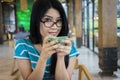 Young woman drinking coffee at cafe Royalty Free Stock Photo