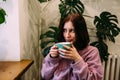 Young woman is drinking coffee in coffee shop. Time for yourself. Royalty Free Stock Photo