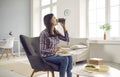 Young woman drinking coffee and eating vegetable salad from takeaway meal delivery Royalty Free Stock Photo