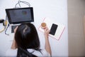 Young woman drinking coffee at home in her bed and checking her laptop, Royalty Free Stock Photo