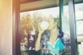 Young woman drinking coffee and reading book sitting indoor in urban cafe Royalty Free Stock Photo