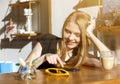 Young woman drinking coffee and reading book sitting indoor in urban cafe. Cafe city lifestyle. Casual portrait of teenager girl Royalty Free Stock Photo