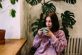 Young woman is drinking coffee in coffee shop. Time for yourself. Royalty Free Stock Photo