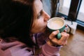 Young woman is drinking coffee in coffee shop. Time for yourself. Royalty Free Stock Photo