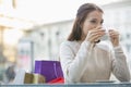 Young woman drinking coffee at sidewalk cafe Royalty Free Stock Photo