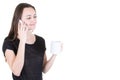 Young woman drinking coffee and using her mobile phone in white background and copy space