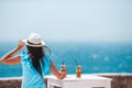 Young woman drinking cold coffee enjoying sea view Royalty Free Stock Photo