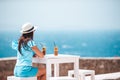 Young woman drinking cold coffee enjoying sea view Royalty Free Stock Photo